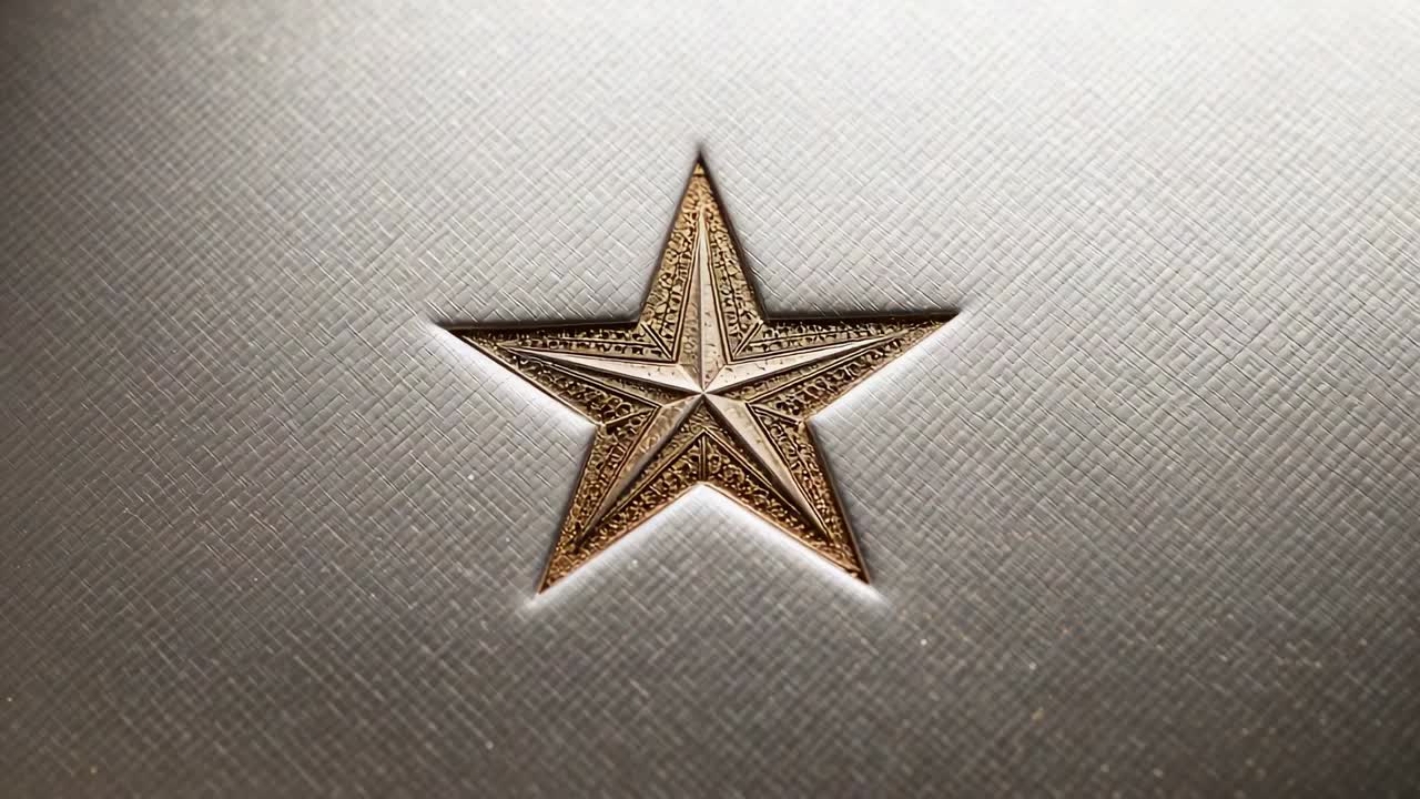 Zooming cam and shifting light revealing recessed gold star on textured metal plate, showing detail