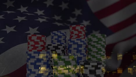 Animation-of-poker-chips,-confetti-and-national-flag-of-america-over-aerial-view-of-buildings