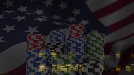 animation of poker chips, confetti and national flag of america over aerial view of buildings