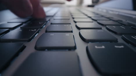 Close-up-Moving-Macro-Shot:-american-user-hands-typing-on-laptop-keyboard-sit-at-table-mixed-race-ethnic-businessman-hipster-student-professional-study-work-with-pc