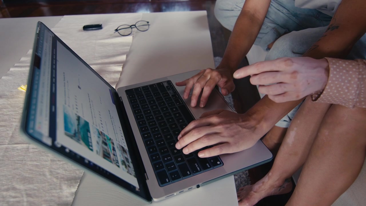 Couple Collaborating on Laptop at Home