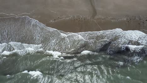 crashing waves on the beach at bunmahon copper coast ireland an incoming tide on a july summer day