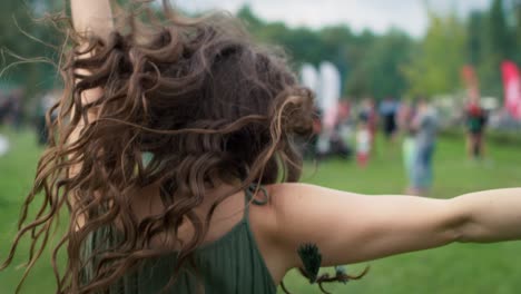 close up of caucasian woman walking and turning to camera side at music festival. shot with red helium camera in 8k.