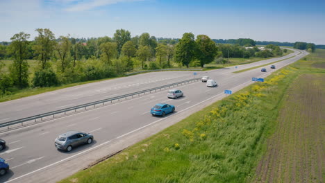 cars driving on a highway. electronic blue automobile moving slowly on the road. highway with flowing traffic. eco transport. aerial view.