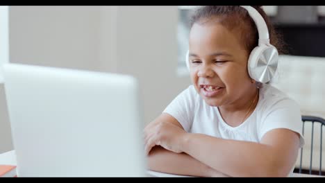 girl enjoying an online class on a laptop