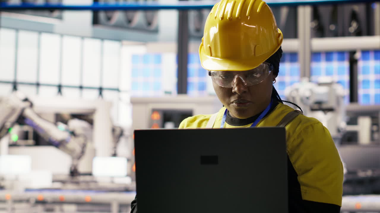 Vertical video Portrait of smiling solar panels factory engineer analyzing data on laptop