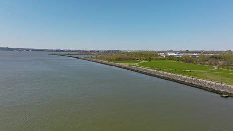 drone flight over upper bay and liberty state park with blue sky and sunny day in jersey city