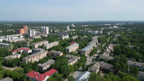 aerial view of a green residential town with many trees and buildings