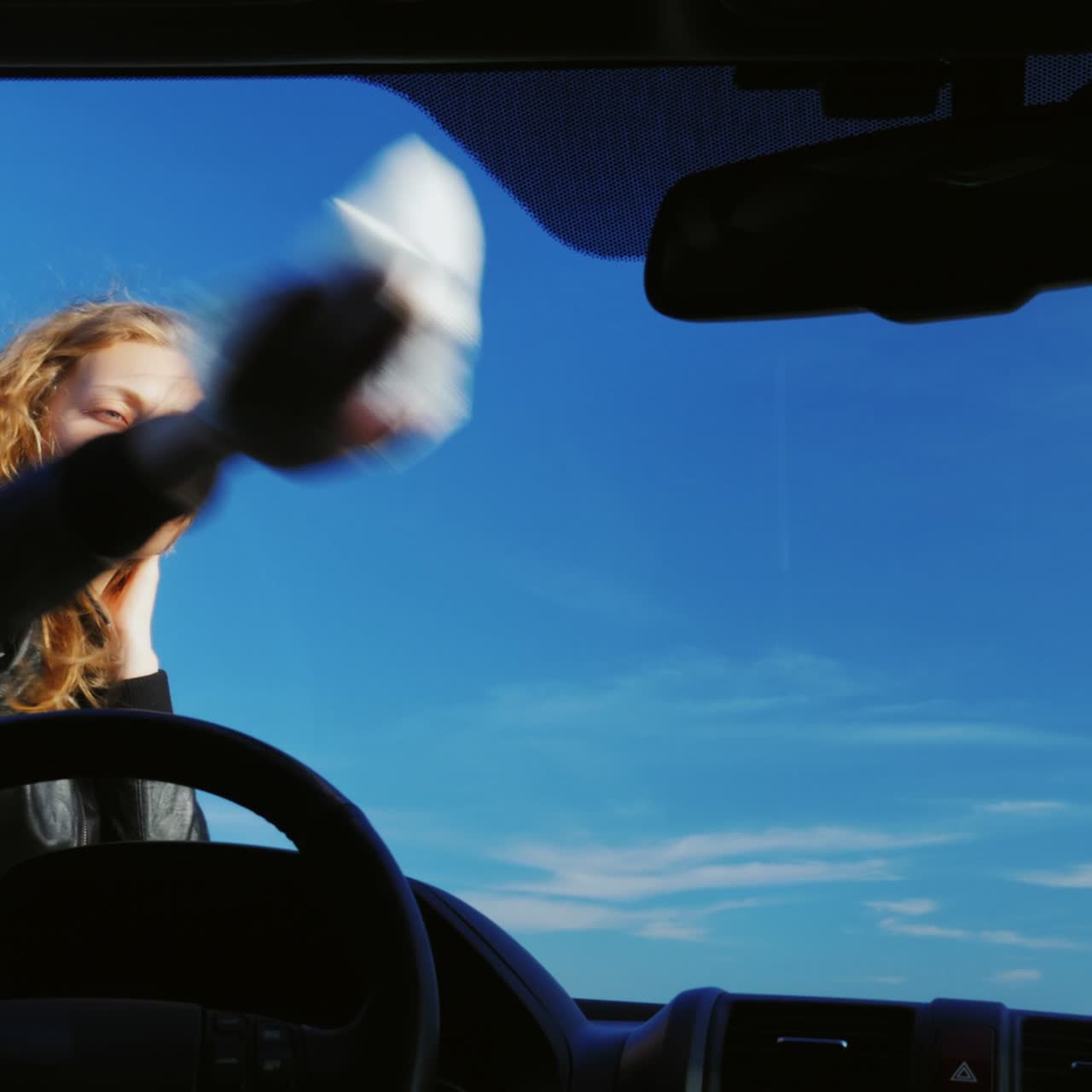 una joven lava su auto en un fregadero de autoservicio