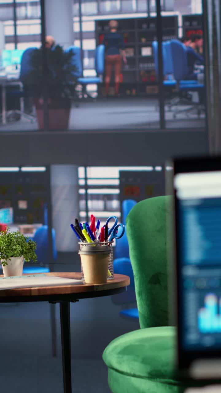 Office Interior with Data Charts on Screen and Stationery on Desk