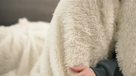 female hand touching the fur blanket white color