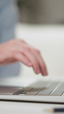 boy student learns to type in english on laptop keyboard with skilled african-american teacher support at private lesson closeup slow motion