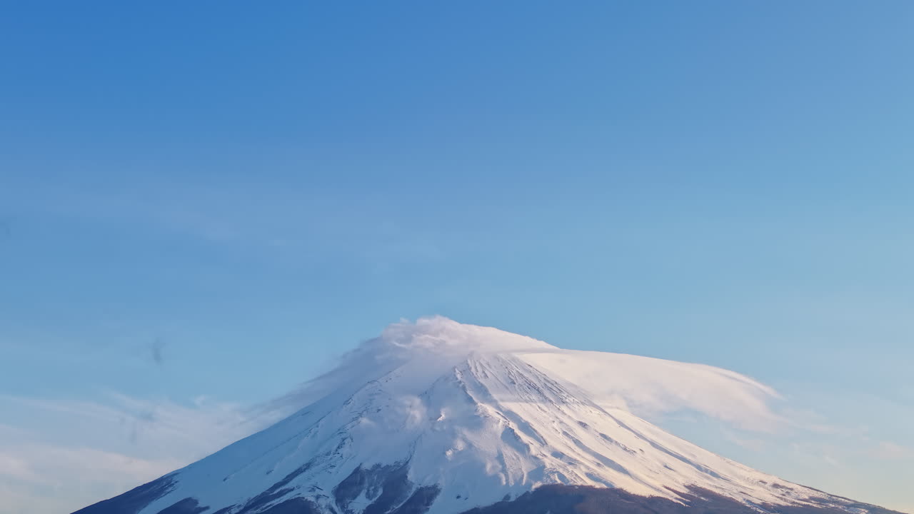 Aerial drone view of Mount Fuji with snow at the top in daylight