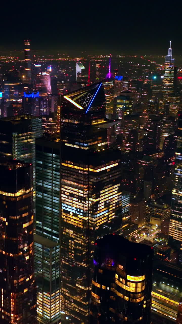 Breath-taking view of scenic New York at night. Drone footage over the endless panorama of never sleeping metropolis. Vertical video