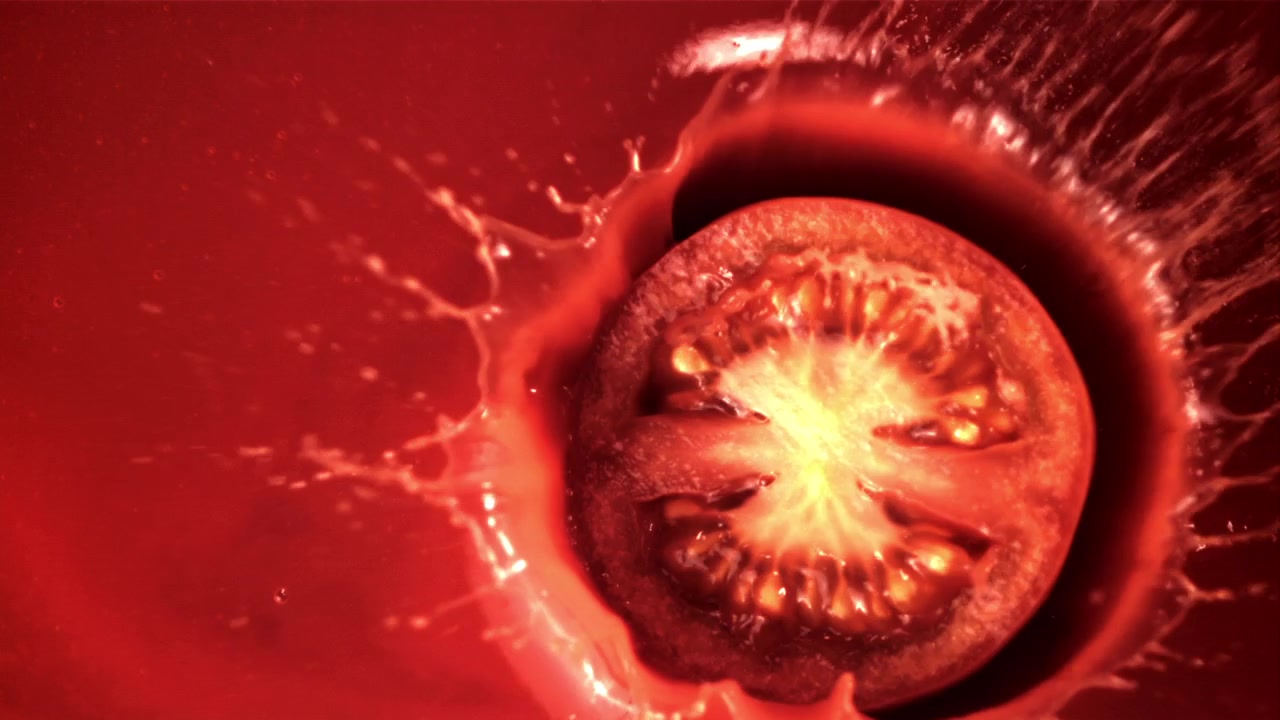 Slow Motion Tomato Slice Splashing into Red Juice