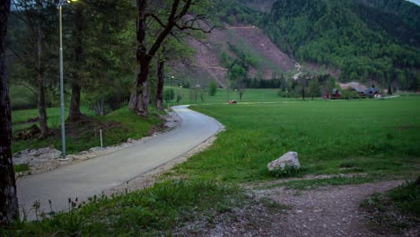 road is leading to a beautiful valley with a few houses