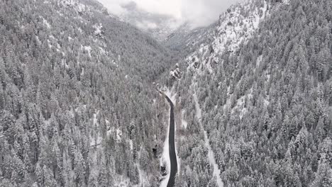 cinematic aerial tilt-up reveal of snowy winter scene in utah mountains