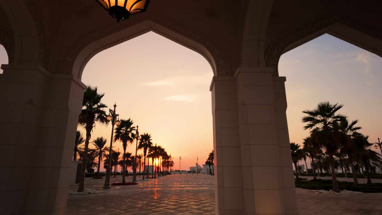 Golden sunset seen from the arches of a resort or palace in the Middle East