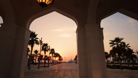 golden sunset seen from the arches of a resort or palace in the middle east