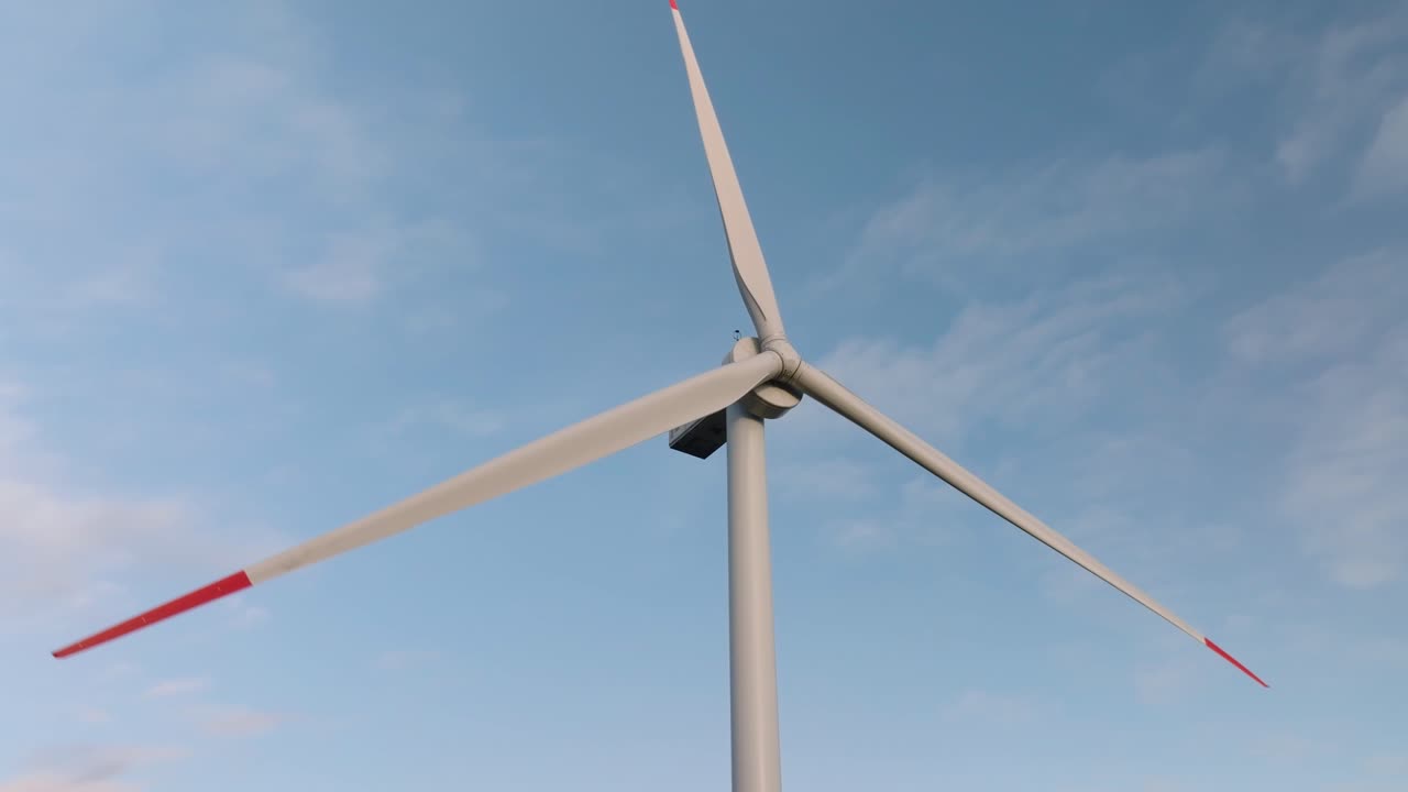 Rotating blades of a wind turbine. Close-up view of green energy propellers. Sustainable modern source