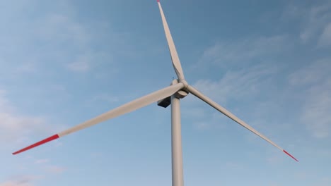 rotating blades of a wind turbine. close-up view of green energy propellers. sustainable modern source