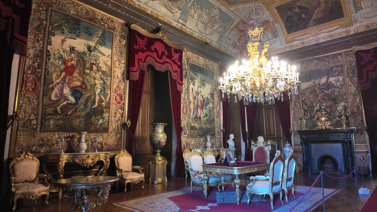 Elegant furniture adorns the Palace of Ajuda, with tapestries and a crystal chandelier adding to the luxurious ambiance