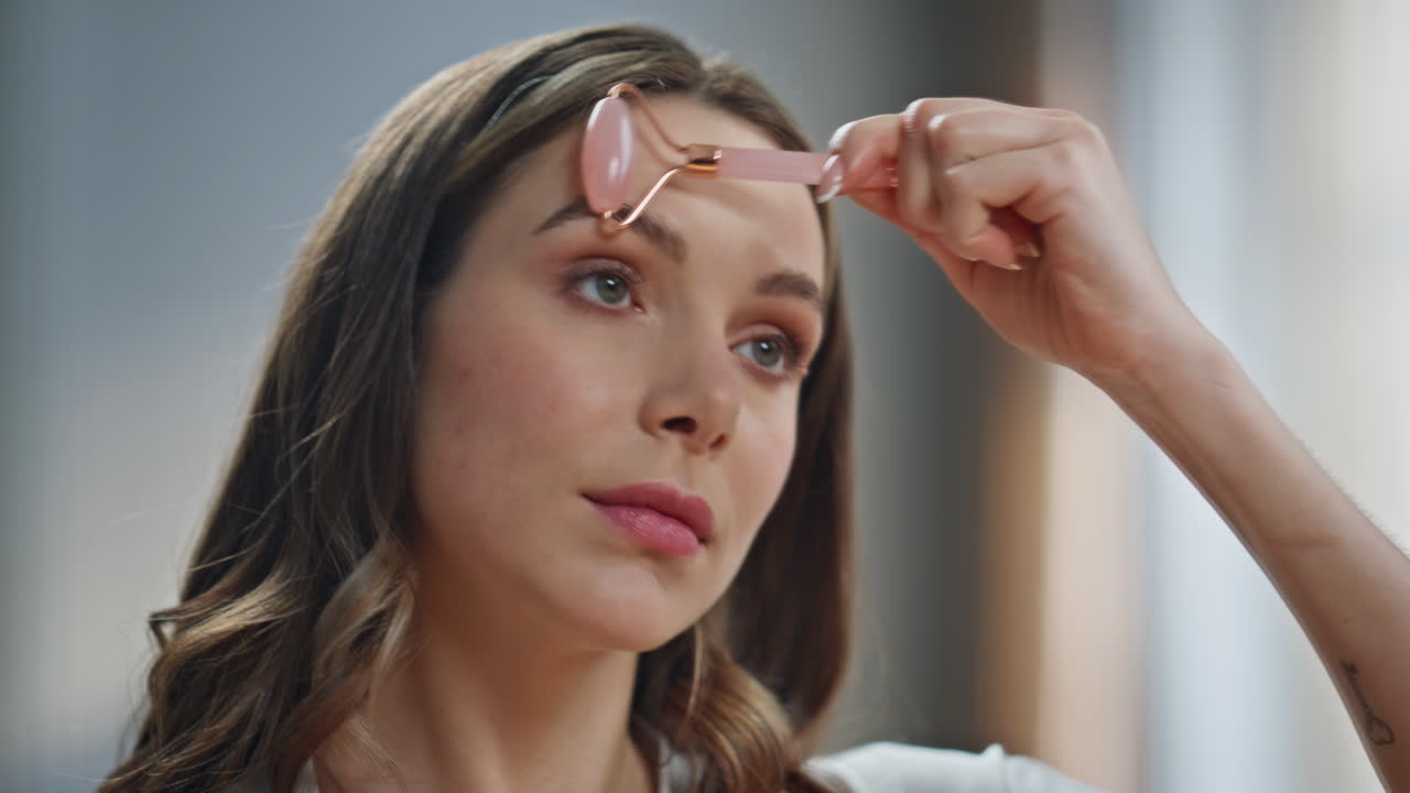 Woman using facial massage roller