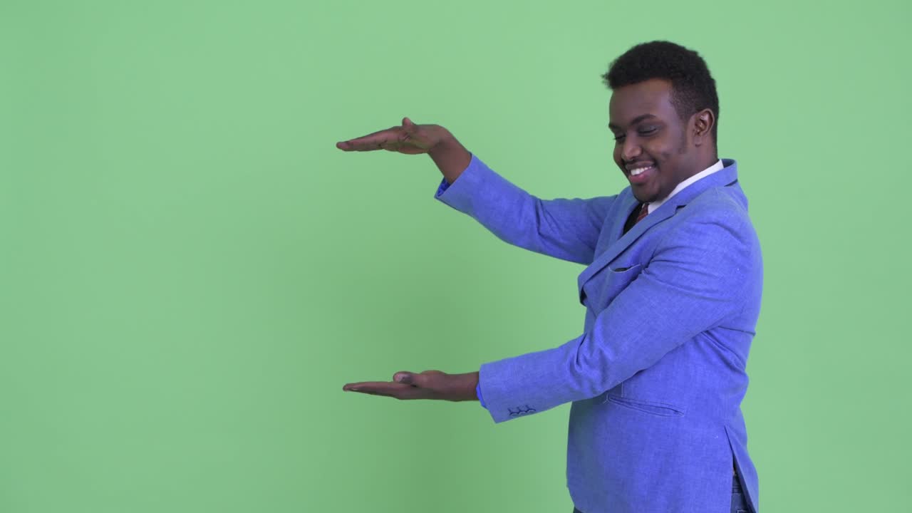 Young African businessman with Afro hair in suit