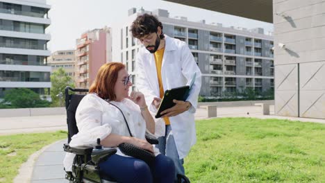 Doctor consulting with a patient in a wheelchair