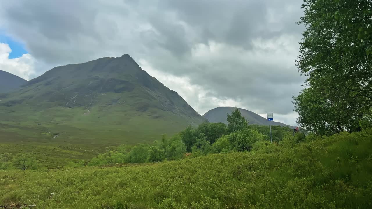 Clouds Over Meadow, Fields, And Mountains In Highlands Of Scotland. - pan shot