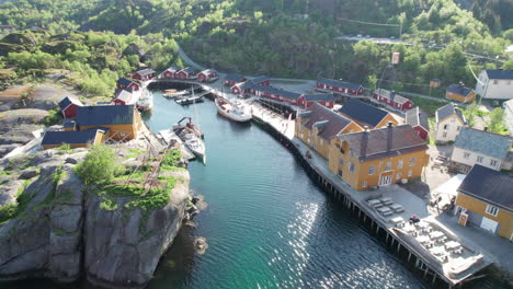 the beauty of nusfjord in spring: yellow houses from the air, lofoten islands, norway