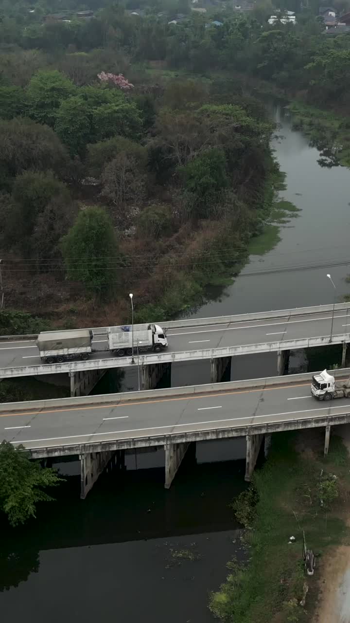Aerial view of trucks on a bridge over a river
