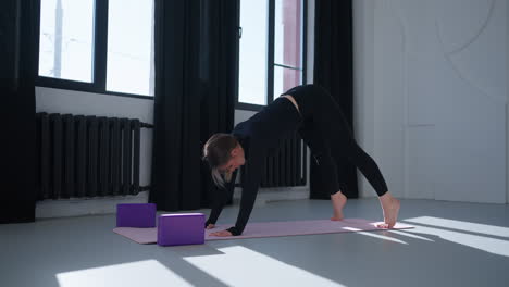 woman practicing yoga in a studio