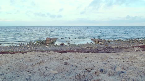 sand close to the river  flowing through rocks