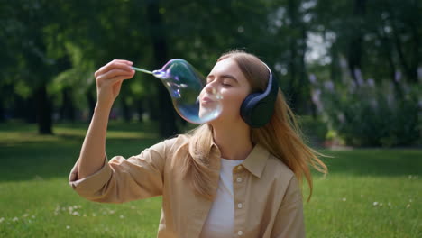 woman blowing bubbles in a park