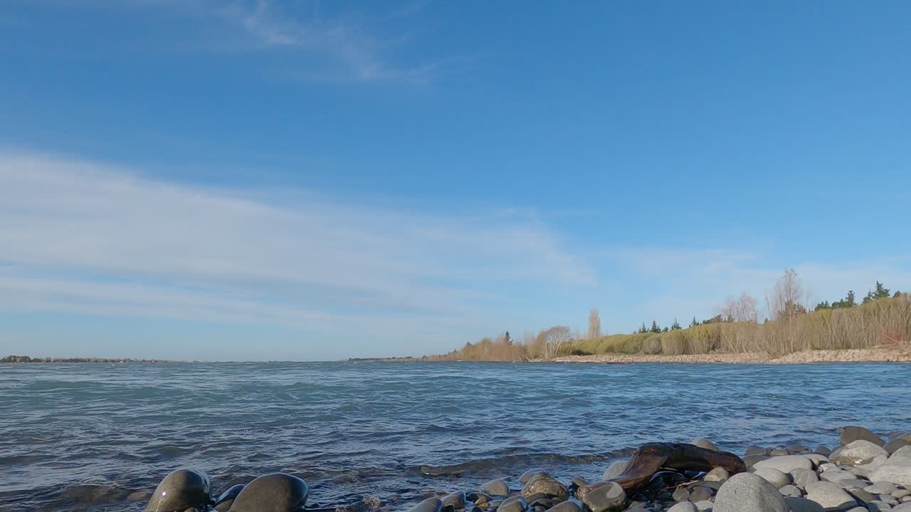 Fast flowing river late afternoon on winter's day in slow-motion - Waimakariri River, New Zealand