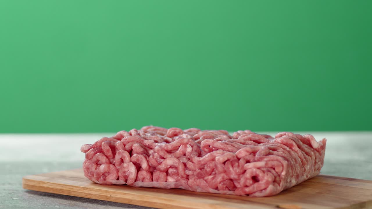 Raw minced meat on the table slowly rotates.