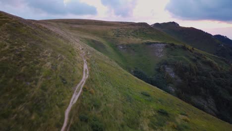 Experience-the-beauty-of-a-summer-mountain-ridge-at-sunset-with-vibrant-colors,-captured-by-a-mesmerizing-drone-footage