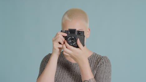 Female-caucasian-photographer-posing-with-retro-camera-02