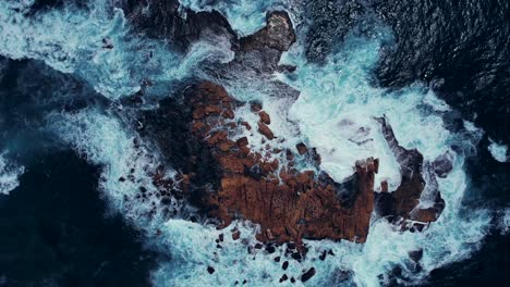 coogee beach, drone shot of waves crashing on rocks, australia