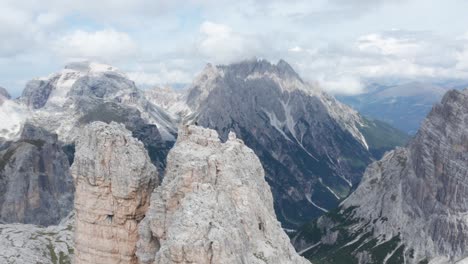 epic aerial shot of alpinist on top of torre di toblin, dolomites, italy