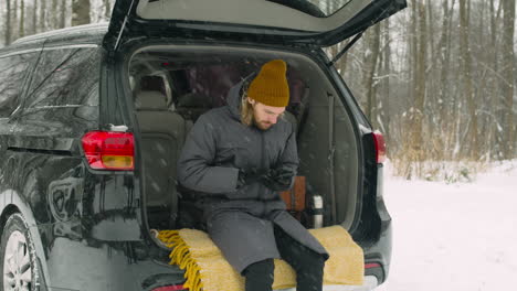 happy friends meeting and hugging on a snowy day before leaving for a winter road trip