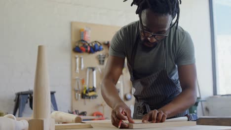 Carpenter marking with pencil on wood 4k