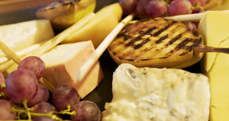 Different-Types-Of-Cheese-On-Wooden-Board-In-The-Restaurant