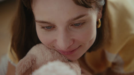 a girl playing with dolls in her room