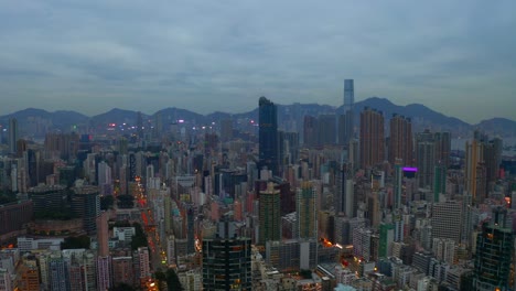 Drone-shot-,traveling-to-the-right,-of-a-big-city-during-a-cloudy-day-with-business-buildings-in-the-distance