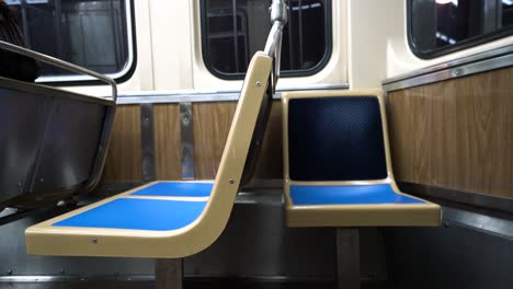 Empty-seats-on-subway-at-night-as-train-approaches-next-station-in-Chicago