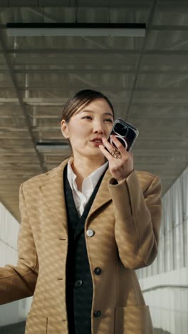 businesswoman on phone call in modern office corridor