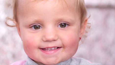 cute blonde girl laughs and looks at the camera cute blonde girl laughs and looks at the camera portrait of a little girl laughing and looking at the camera