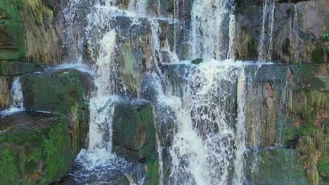 Aerial-drone-footage-of-a-tall-rocky-waterfall-in-the-Yorkshire-Dales,-Pennies